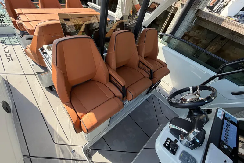  Yacht Photos Pics 2024 Saxdor 320 GTO boat interior with brown leather seats and modern steering console.