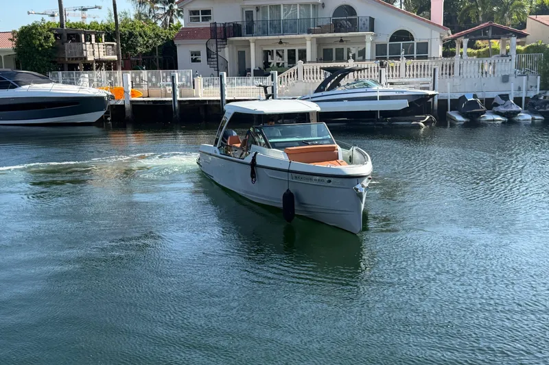  Yacht Photos Pics 2024 Saxdor 320 GTO boat cruising in a serene waterfront setting.