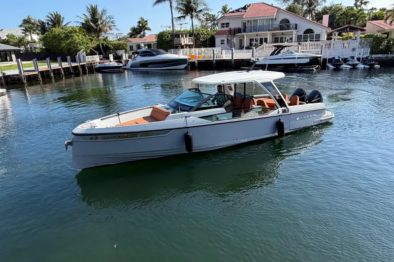  Yacht Photos Pics 2024 Saxdor 320 GTO boat on calm water near waterfront homes.