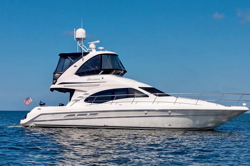 Shell’s Island II Yacht Photos Pics 2008 Sea Ray 44 Sedan Bridge yacht on calm blue water.