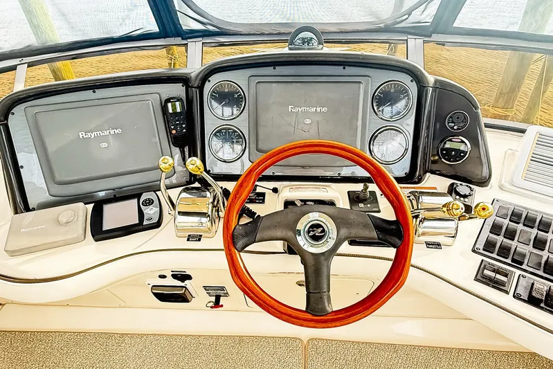 Shell’s Island II Yacht Photos Pics 2008 Sea Ray 44 Sedan Bridge helm with Raymarine electronics and wooden steering wheel.