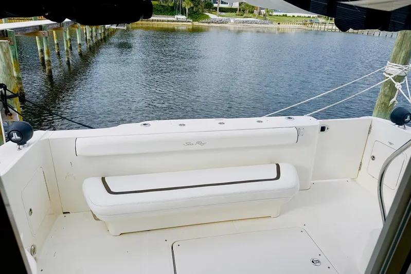 Shell’s Island II Yacht Photos Pics 2008 Sea Ray 44 Sedan Bridge yacht deck with white seating, docked by calm water.