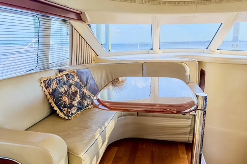 Shell’s Island II Yacht Photos Pics Luxurious interior of 2008 Sea Ray 44 Sedan Bridge yacht with elegant seating and table.