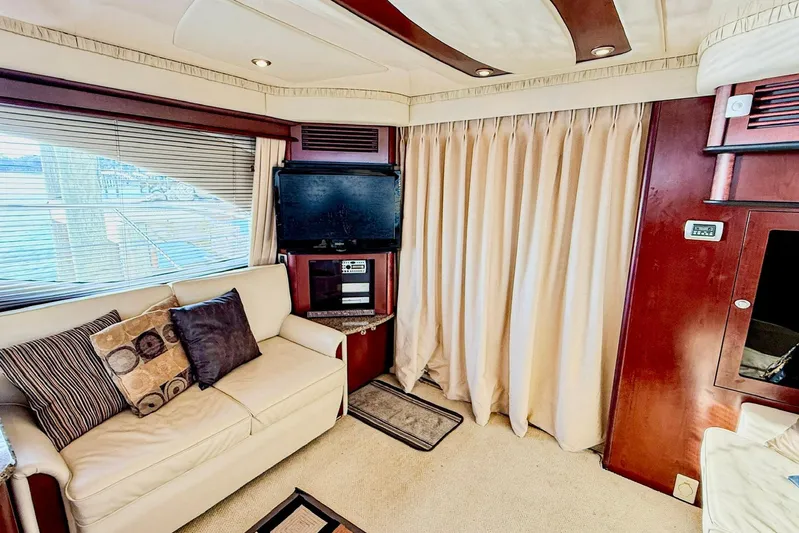 Shell’s Island II Yacht Photos Pics Luxurious interior of 2008 Sea Ray 44 Sedan Bridge with sofa, TV, and elegant decor.