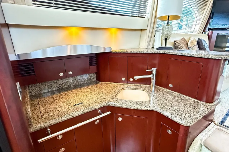 Shell’s Island II Yacht Photos Pics Luxurious kitchen area in a 2008 Sea Ray 44 Sedan Bridge yacht with granite countertops.