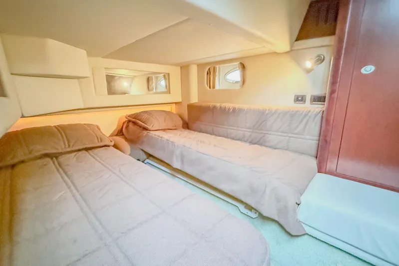 Shell’s Island II Yacht Photos Pics Interior cabin of 2008 Sea Ray 44 Sedan Bridge with twin beds and soft lighting.