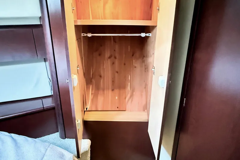 Shell’s Island II Yacht Photos Pics Open wooden closet inside 2008 Sea Ray 44 Sedan Bridge yacht interior.