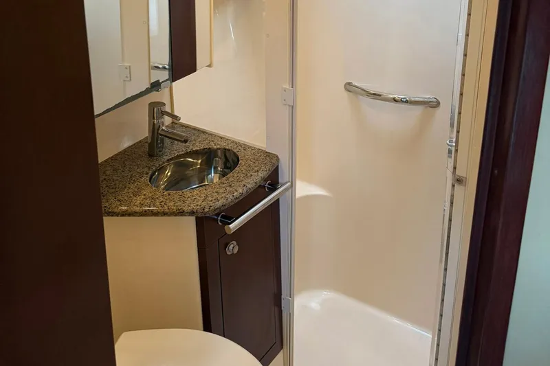 Shell’s Island II Yacht Photos Pics Luxurious bathroom in 2008 Sea Ray 44 Sedan Bridge yacht with granite countertop and modern fixtures.