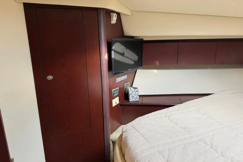 Shell’s Island II Yacht Photos Pics Interior of 2008 Sea Ray 44 Sedan Bridge with TV and wooden cabinetry.