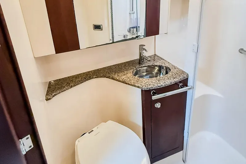 Shell’s Island II Yacht Photos Pics Luxurious bathroom in 2008 Sea Ray 44 Sedan Bridge yacht with granite countertop.