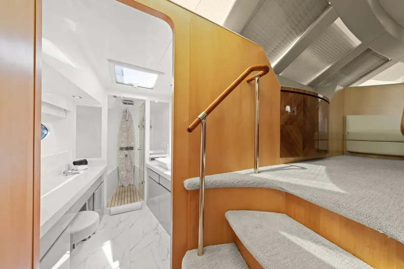 Tranquility Yacht Photos Pics Interior of 2013 Horizon PC60 yacht, featuring modern bathroom and elegant staircase design.