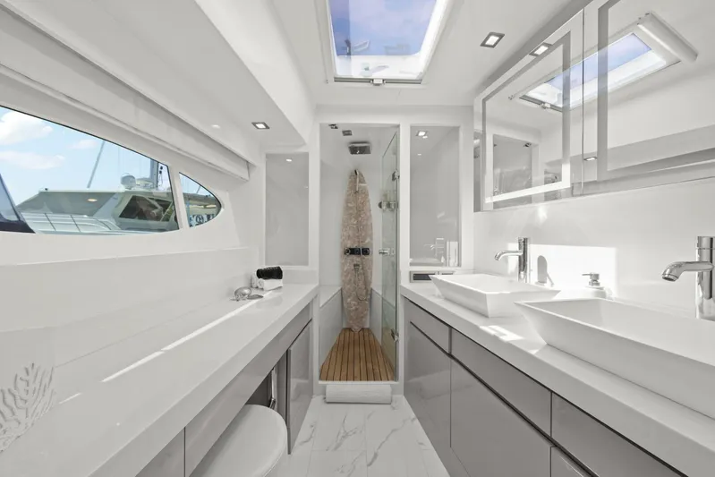 Tranquility Yacht Photos Pics Luxurious bathroom interior of 2013 Horizon PC60 yacht with modern fixtures and skylight.