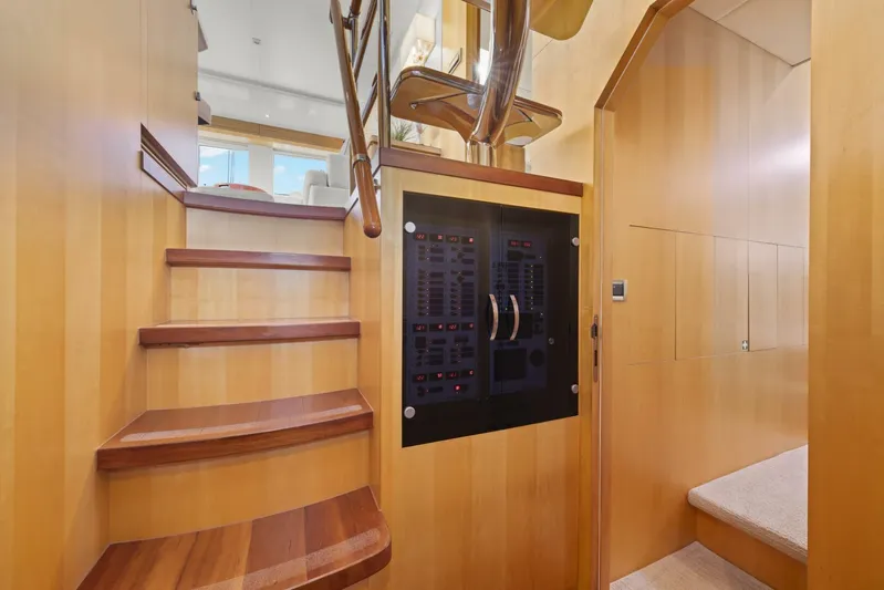 Tranquility Yacht Photos Pics Interior of 2013 Horizon PC60 yacht with wooden stairs and control panel.