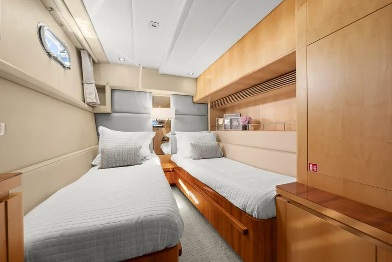 Tranquility Yacht Photos Pics Interior of 2013 Horizon PC60 yacht with twin beds and wooden furnishings.