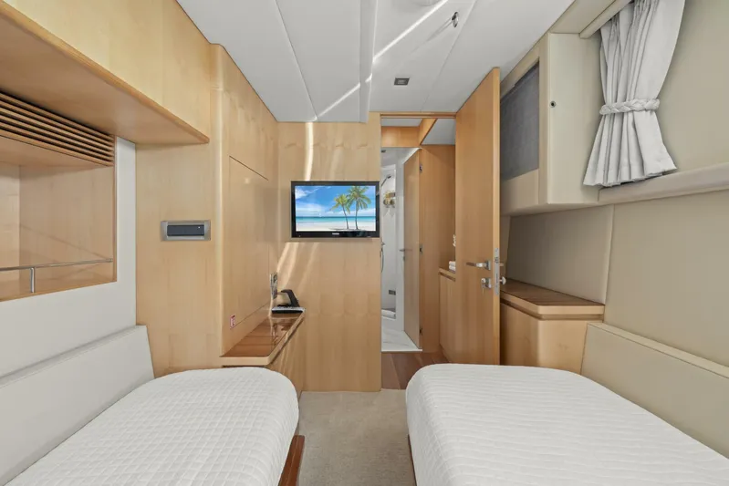 Tranquility Yacht Photos Pics Luxurious cabin interior of 2013 Horizon PC60 yacht with twin beds and TV.