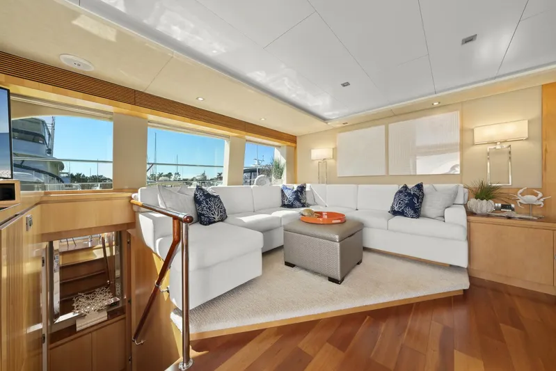 Tranquility Yacht Photos Pics Luxurious interior of 2013 Horizon PC60 yacht with white sectional sofa and elegant decor.
