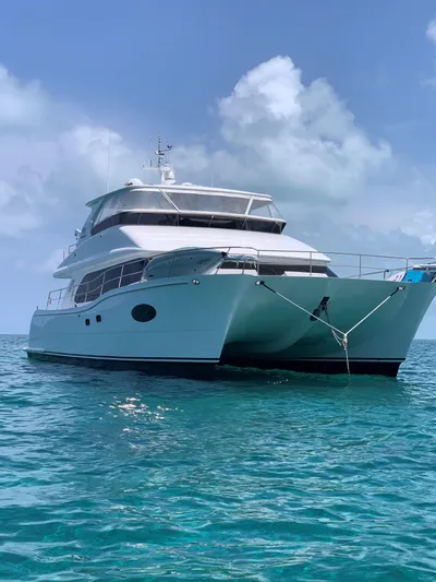 Tranquility Yacht Photos Pics Luxurious 2013 Horizon PC60 yacht anchored on clear blue ocean waters.