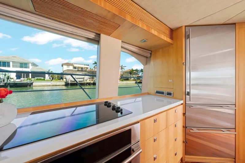 Tranquility Yacht Photos Pics Modern yacht kitchen interior with large windows, sleek appliances, and waterfront view. Horizon PC60, 2013.