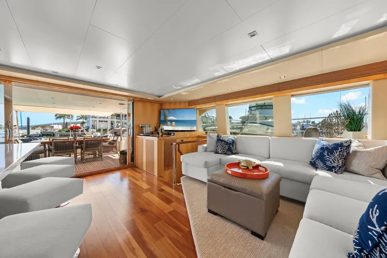 Tranquility Yacht Photos Pics Luxurious Horizon PC60 yacht interior, featuring elegant seating, wooden flooring, and a spacious outdoor deck.