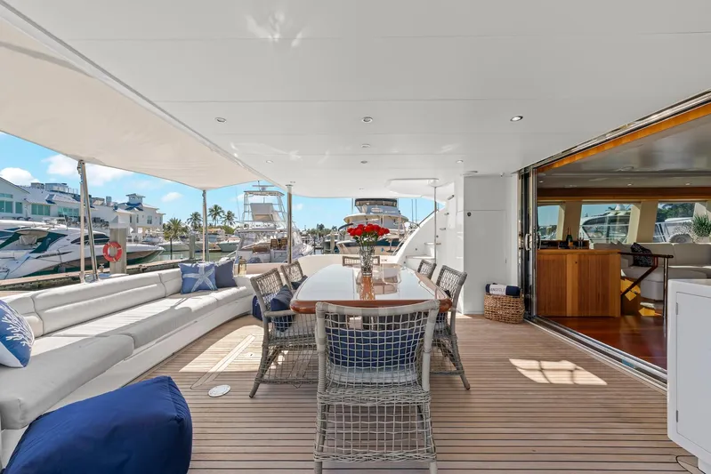 Tranquility Yacht Photos Pics Luxurious Horizon PC60 yacht deck with elegant seating and dining area, docked at marina.