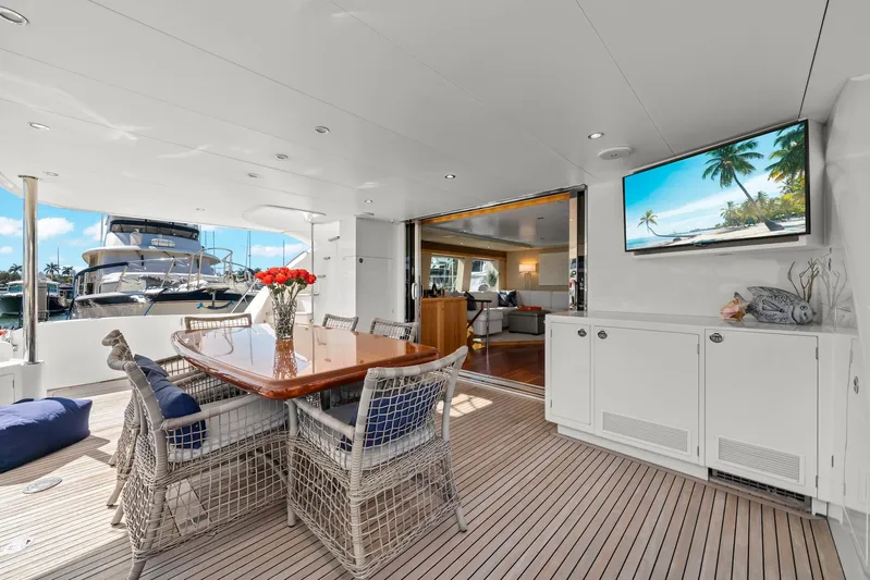 Tranquility Yacht Photos Pics Luxurious Horizon PC60 yacht deck with dining area, TV, and marina view, 2013 model.