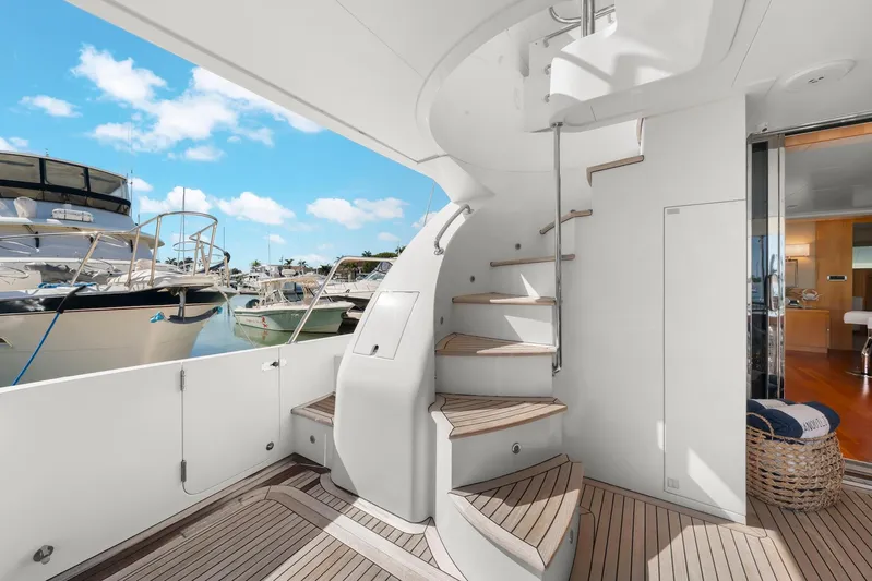 Tranquility Yacht Photos Pics Luxurious 2013 Horizon PC60 yacht interior with spiral staircase and marina view.