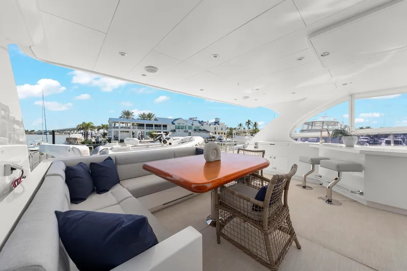 Tranquility Yacht Photos Pics Luxurious Horizon PC60 yacht deck with seating, table, and marina view, 2013 model.
