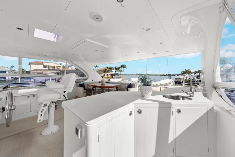Tranquility Yacht Photos Pics Luxurious 2013 Horizon PC60 yacht interior with helm, seating, and waterfront view.
