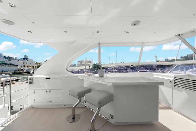 Tranquility Yacht Photos Pics Luxurious Horizon PC60 yacht interior with modern bar stools and panoramic marina view.