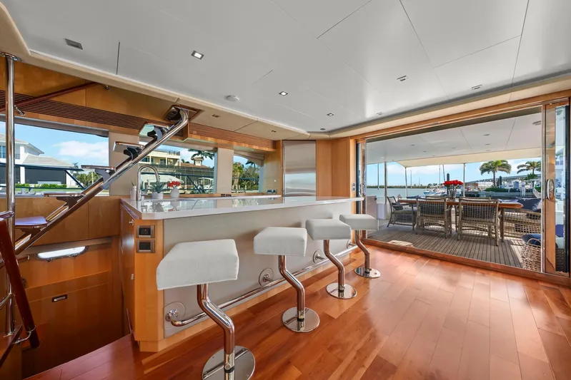 Tranquility Yacht Photos Pics Luxurious Horizon PC60 yacht interior with bar stools and outdoor dining area, 2013 model.