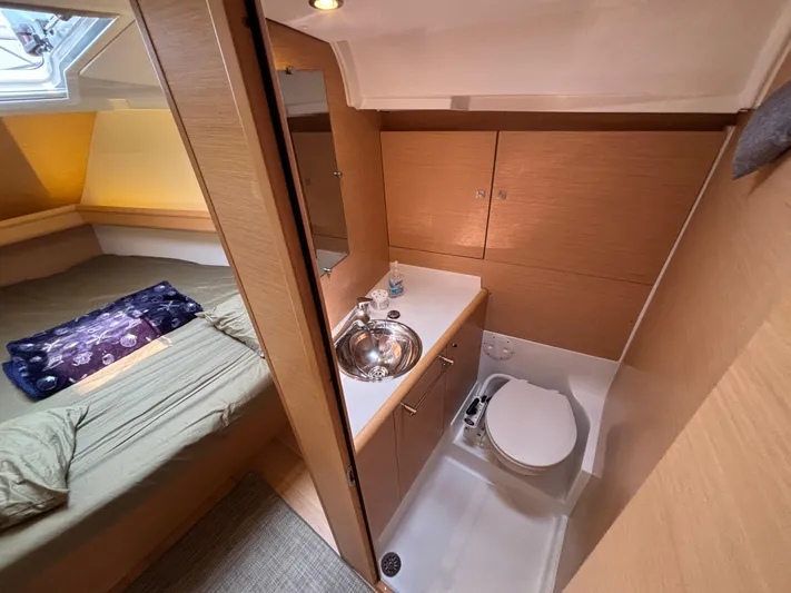 Khushali Yacht Photos Pics 2019 Jeanneau Sun Odyssey 419 interior with cozy cabin and compact bathroom.