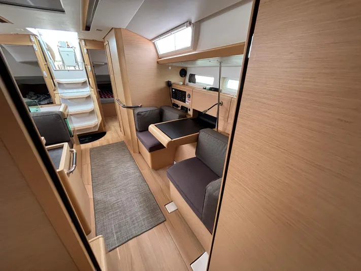 Khushali Yacht Photos Pics 2019 Jeanneau Sun Odyssey 419 interior with modern wood finish and seating area.