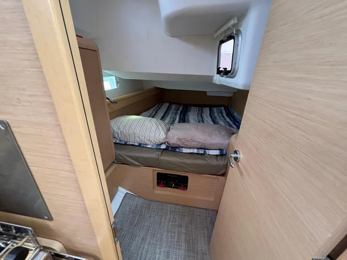 Khushali Yacht Photos Pics Cozy cabin interior of 2019 Jeanneau Sun Odyssey 419 sailboat with bed and window.