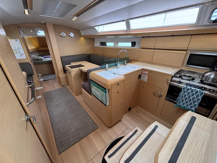 Khushali Yacht Photos Pics Interior of 2019 Jeanneau Sun Odyssey 419 yacht, featuring modern kitchen and seating area.