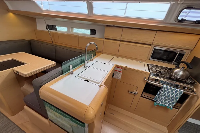 Khushali Yacht Photos Pics Interior of 2019 Jeanneau Sun Odyssey 419 yacht, featuring modern kitchen and seating area.