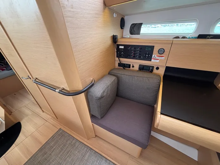 Khushali Yacht Photos Pics Interior of 2019 Jeanneau Sun Odyssey 419 yacht with navigation panel and seating area.