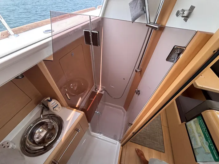 Khushali Yacht Photos Pics Interior of 2019 Jeanneau Sun Odyssey 419 yacht, featuring compact bathroom with shower and sink.