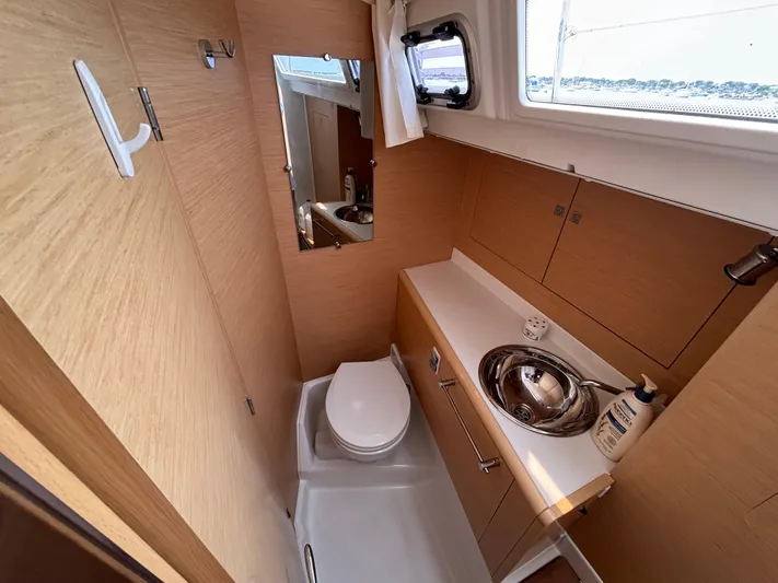 Khushali Yacht Photos Pics Modern bathroom in 2019 Jeanneau Sun Odyssey 419 yacht, featuring sleek design and compact amenities.
