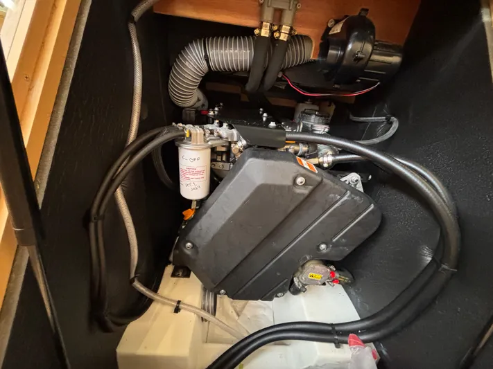 Khushali Yacht Photos Pics Engine compartment of a 2019 Jeanneau Sun Odyssey 419 sailboat, showcasing mechanical components.