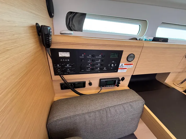 Khushali Yacht Photos Pics Interior control panel of 2019 Jeanneau Sun Odyssey 419 sailboat, featuring navigation and communication equipment.
