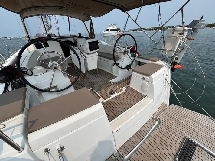 Khushali Yacht Photos Pics 2019 Jeanneau Sun Odyssey 419 sailboat cockpit with dual steering wheels and teak decking.