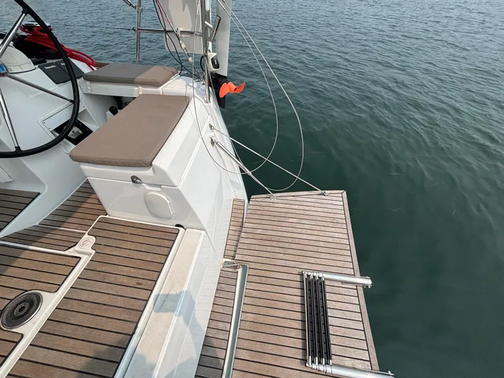 Khushali Yacht Photos Pics 2019 Jeanneau Sun Odyssey 419 yacht deck with wooden finish and water view.