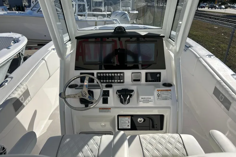  Yacht Photos Pics 2026 Sea Fox 288 Commander boat dashboard with steering wheel and control panel.