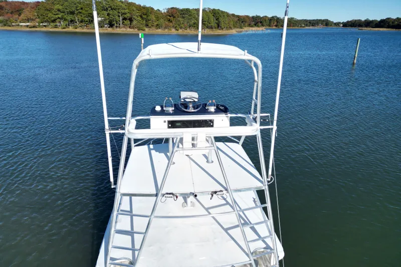 Sea Dated Yacht Photos Pics Aerial view of 1996 Cabo 35 boat on calm water near a wooded shoreline.