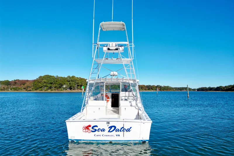 Sea Dated Yacht Photos Pics 1996 Cabo 35 boat named "Sea Dated" on calm water, Cape Charles, VA.