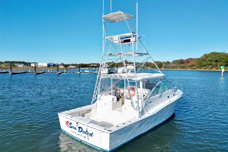 Sea Dated Yacht Photos Pics 1996 Cabo 35 boat on calm water with clear blue sky.