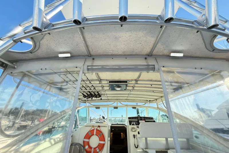 Sea Dated Yacht Photos Pics Interior view of a 1996 Cabo 35 boat with fishing rods and life preserver.