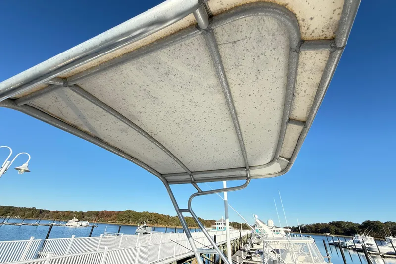 Sea Dated Yacht Photos Pics 1996 Cabo 35 boat canopy with marina view under clear blue sky.