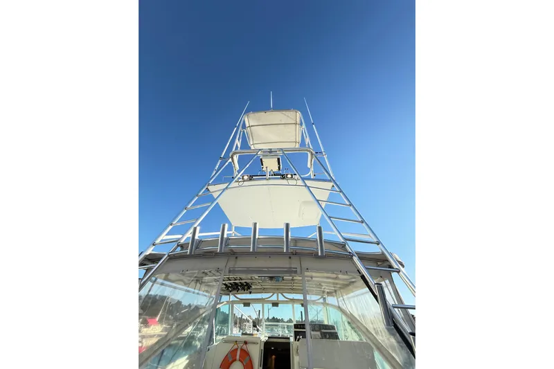 Sea Dated Yacht Photos Pics 1996 Cabo 35 boat tower against clear blue sky.