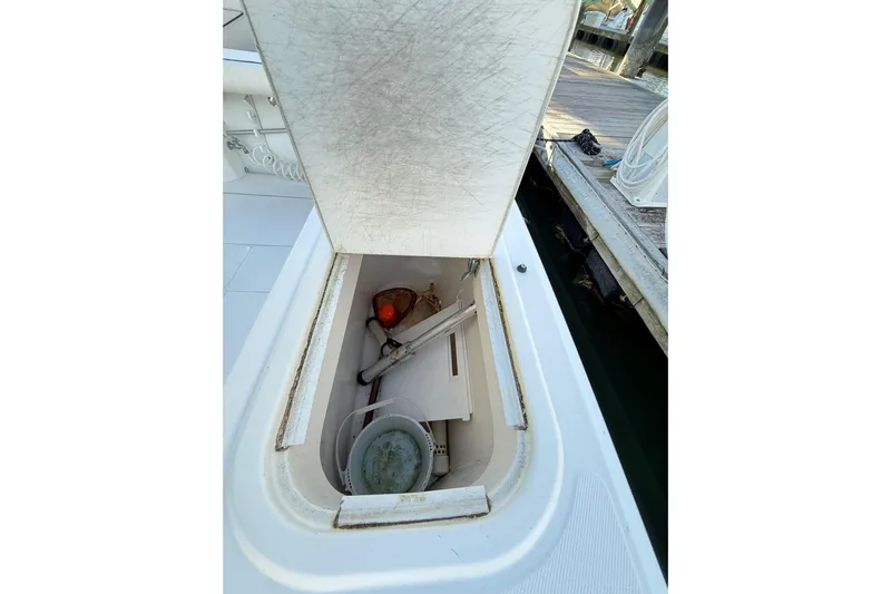 Sea Dated Yacht Photos Pics Open storage compartment on a 1996 Cabo 35 boat, dockside view.